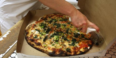 A pizza is prepared for a take out customer at Frank Pepe Pizzeria on Wooster Street in New Haven's Little Italy.