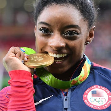 Hairstyle, Earrings, Eyelash, Tooth, Award, Gold medal, Portrait photography, Eating, Snack, 