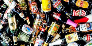 Bottle, Alcohol, Alcoholic beverage, Glass bottle, Drink, Distilled beverage, Logo, Label, Barware, Bottle cap, 