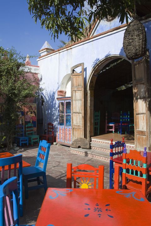 Majorelle blue, Furniture, Table, Outdoor furniture, Arch, Outdoor table, Shade, Patio, Hacienda, Outdoor structure, 