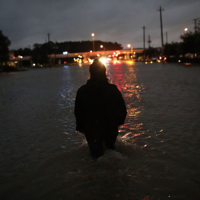 A woman walks through Hurricane Harvey flood waters in Texas.
