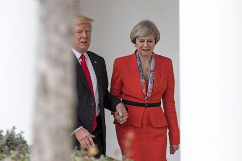 WASHINGTON, DC - JANUARY 27: British Prime Minister Theresa May and U.S. President Donald Trump walk along The Colonnade of the West Wing at The White House on January 27, 2017 in Washington, DC. British Prime Minister Theresa May is on a two-day visit to the United States and will be the first world leader to meet with President Donald Trump - Theresa May responds to holding his hand