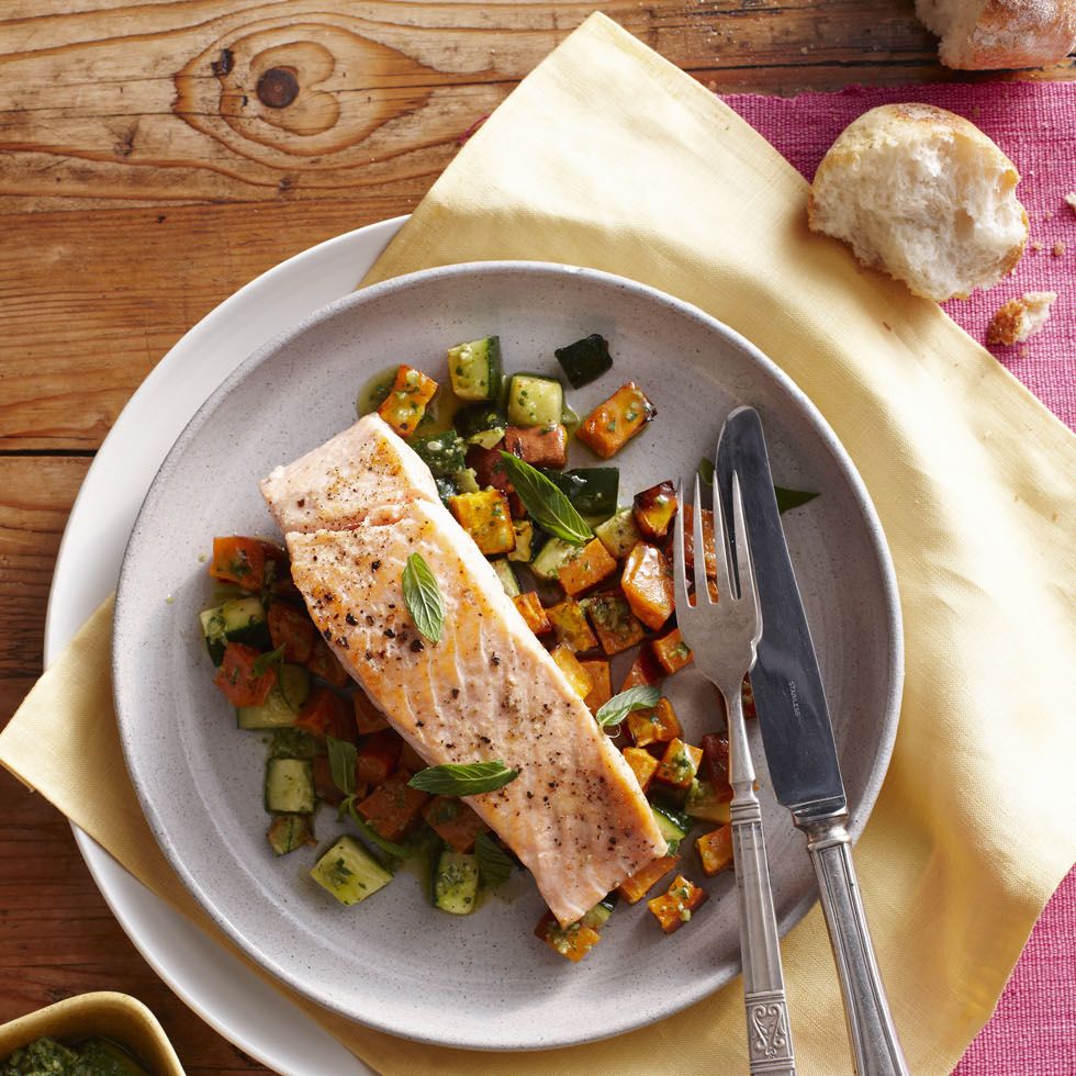 a grey plate with baked salmon on top of bed of vegetables, a good housekeeping pick for a healthy weight loss food