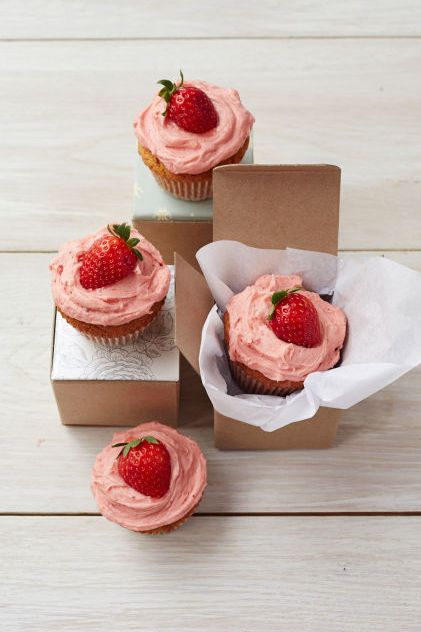 peanut butter and jelly cupcakes with pink frosting and strawberries on top