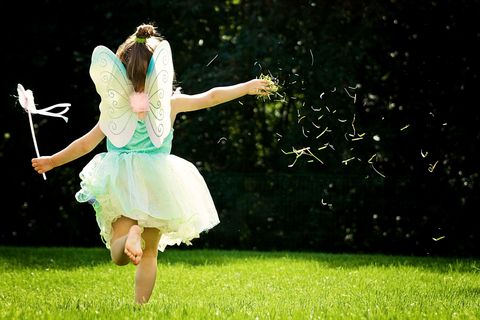 little girl running in a fairy costume