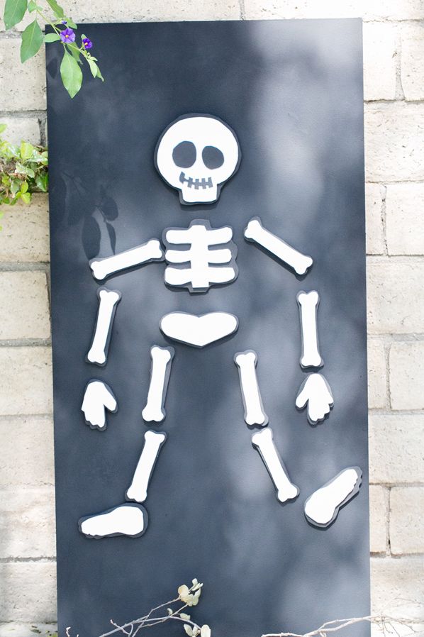 Halloween game, skeleton puzzle attached to a black magnetic board