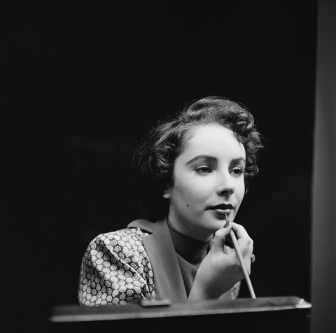 Touching up her lipstick in November of 1948.