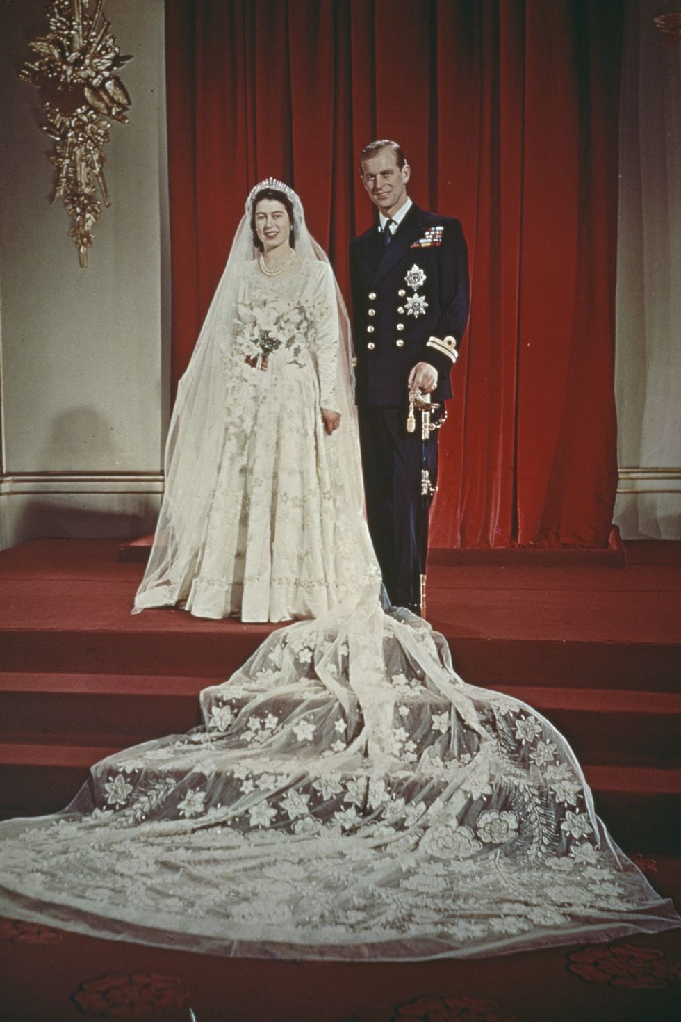 Princess Elizabeth and Prince Philip, Duke of Edinburgh pose together at Buckingham Palace after their wedding ceremony at Westminster Abbey in London on 20th November 1947. Elizabeth wears a wedding gown designed by Norman Hartnell.