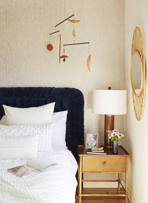 bedroom ideas, gold accents and blue headboard in bedroom