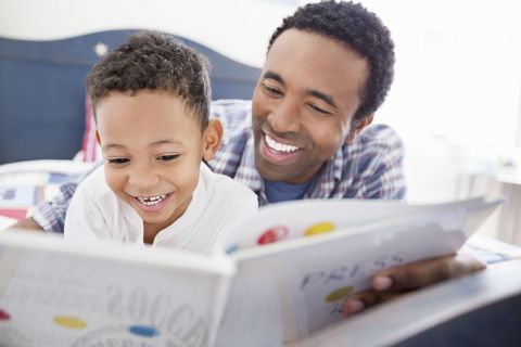 father reading to his son child