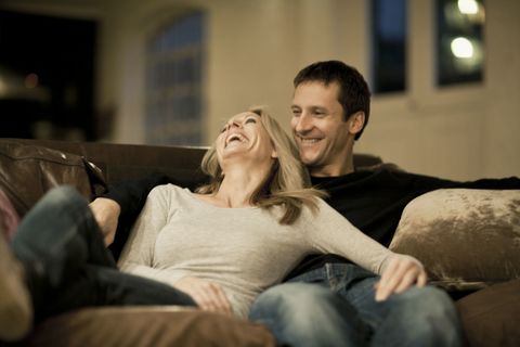 couple laughing on couch