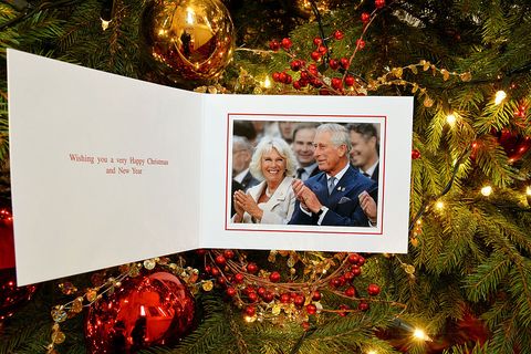 The personal Christmas card produced for Camilla, Duchess of Cornwall and Prince Charles, Prince of Wales, featuring them in a photograph by Christopher Jackson of Getty Images with the couple laughing during the Invictus Games Opening Ceremony on September 10, 2014 hangs on a Christmas tree on December 11, 2014 in London, England.
