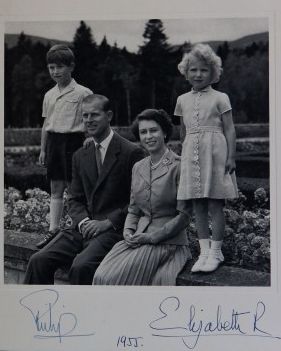 A photograph from a Christmas card dated 1955 showing Queen Elizabeth II and the Duke of Edinburgh alongside children Prince Charles and Princess Anne.