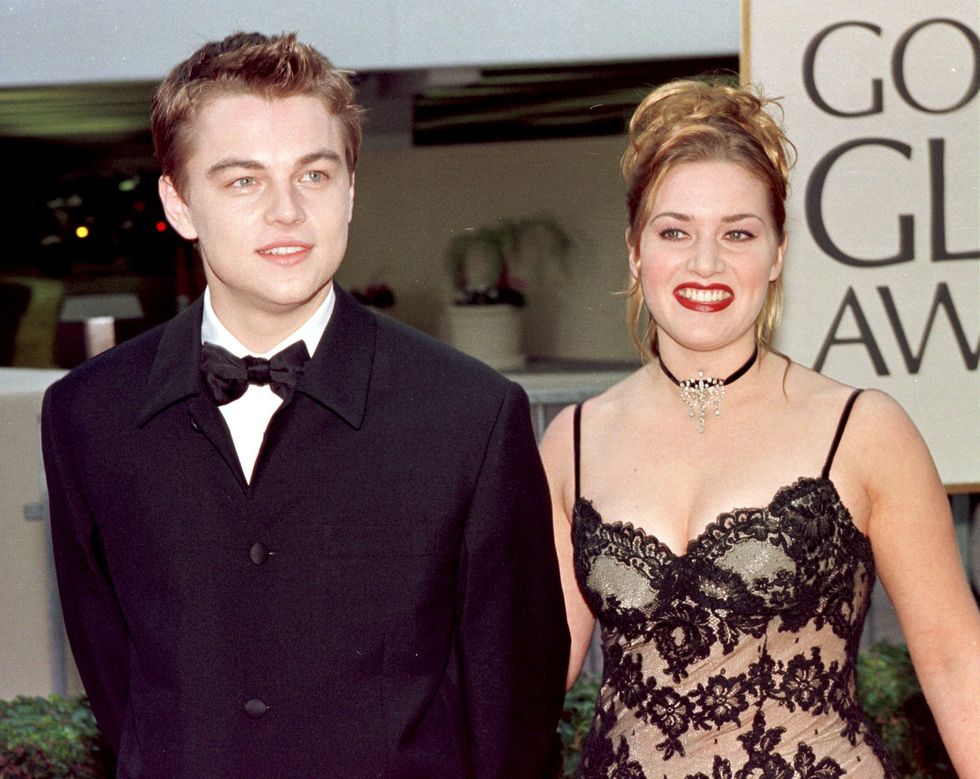 Actor Leonardo DiCaprio (L) arrives with actress and Titanic co-star Kate Winslet for the 55th Annual Golden Globe Awards at the Beverly Hilton 18 January 1998 in Beverly Hills, CA. DiCaprio is nominated for Best Actor in the drama category for his role in 'Titanic'. 'Titanic' is also nominated for Best Picture, Best Director and Best Actress in the same category