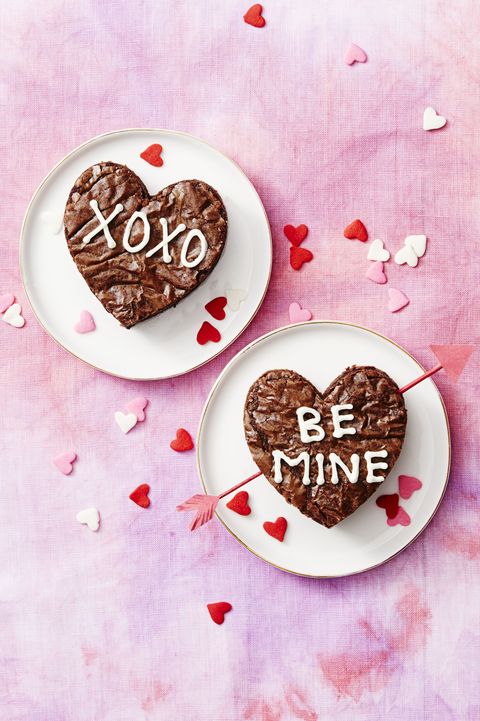valentine's day brownies on a pink background with heart confetti