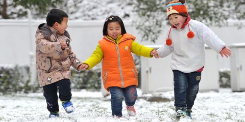 Three children play in snow on January 21, 2016 in Nanjing, Jiangsu Province of China. Jiangsu Province encountered heavy snow in south China with the temperature lowering sharply 9 degrees Celsius to 11 degrees Celsius on weekends.