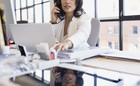 woman working office job payday bills computer