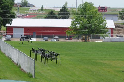 High school football coach Ed Thomas, for whom the newly constructed football field is named, was shot and killed in the temporary weight room (red building) by a former player on June 24, 2009 in Parkersburg, Iowa. Thomas had been a coach at Aplington-Parkersburg High School for 34 years. A 24-year-old suspect has been arrested.