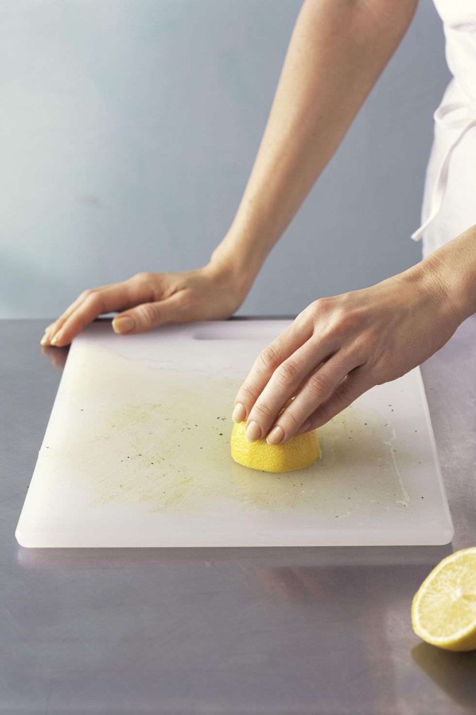 cleaning cutting board with sliced lemon
