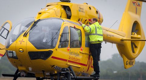 Prince William, The Duke of Cambridge performs checks on his helicopter as he begins his new job with the East Anglian Air Ambulance (EAAA) at Cambridge Airport on July 13, 2015 in Cambridge, England. The former RAF search and rescue helicopter pilot will work as a co-pilot transporting patients to hospital from emergencies ranging from road accidents to heart attacks.