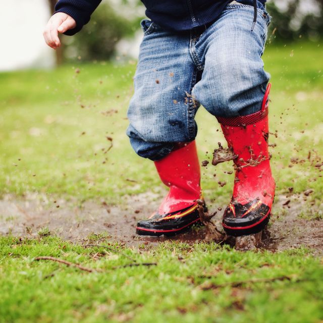 bratty kid jumping in mud puddles