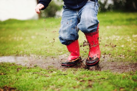 bratty kid jumping in mud puddles