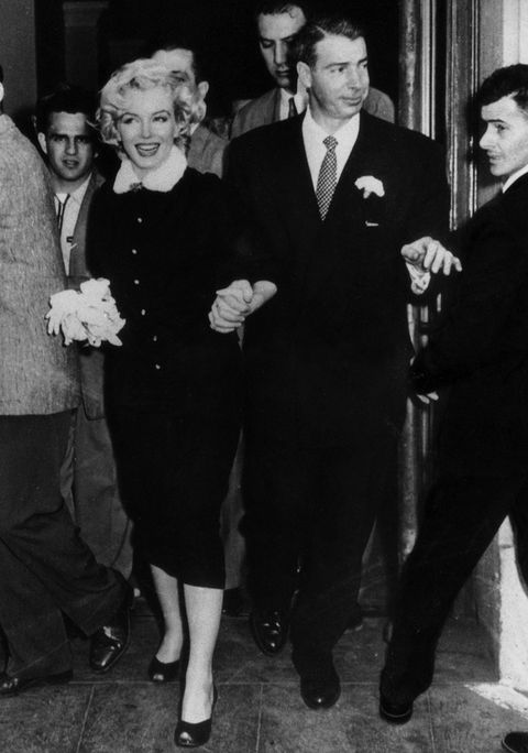 The American actress Marilyn Monroe and her husband Joe DiMaggio leaving the town hall after their wedding. San Francisco, 14th January 1954 (Photo by Mondadori Portfolio via Getty Images)