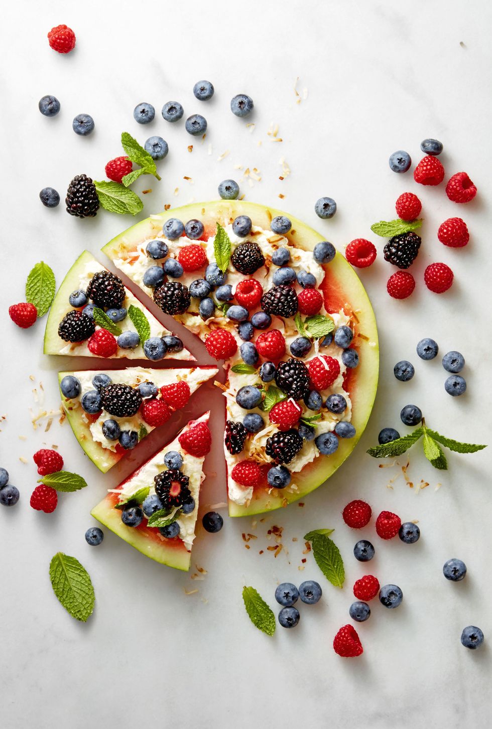 watermelon pizza with berries served on top