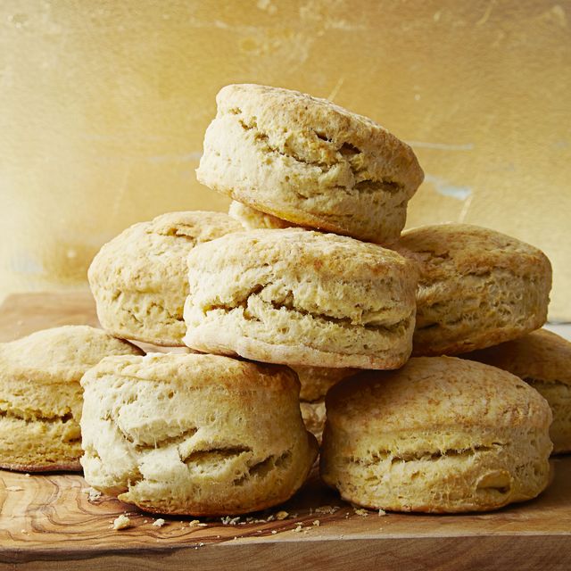 a stack of buttermilk biscuits on a wooden slab