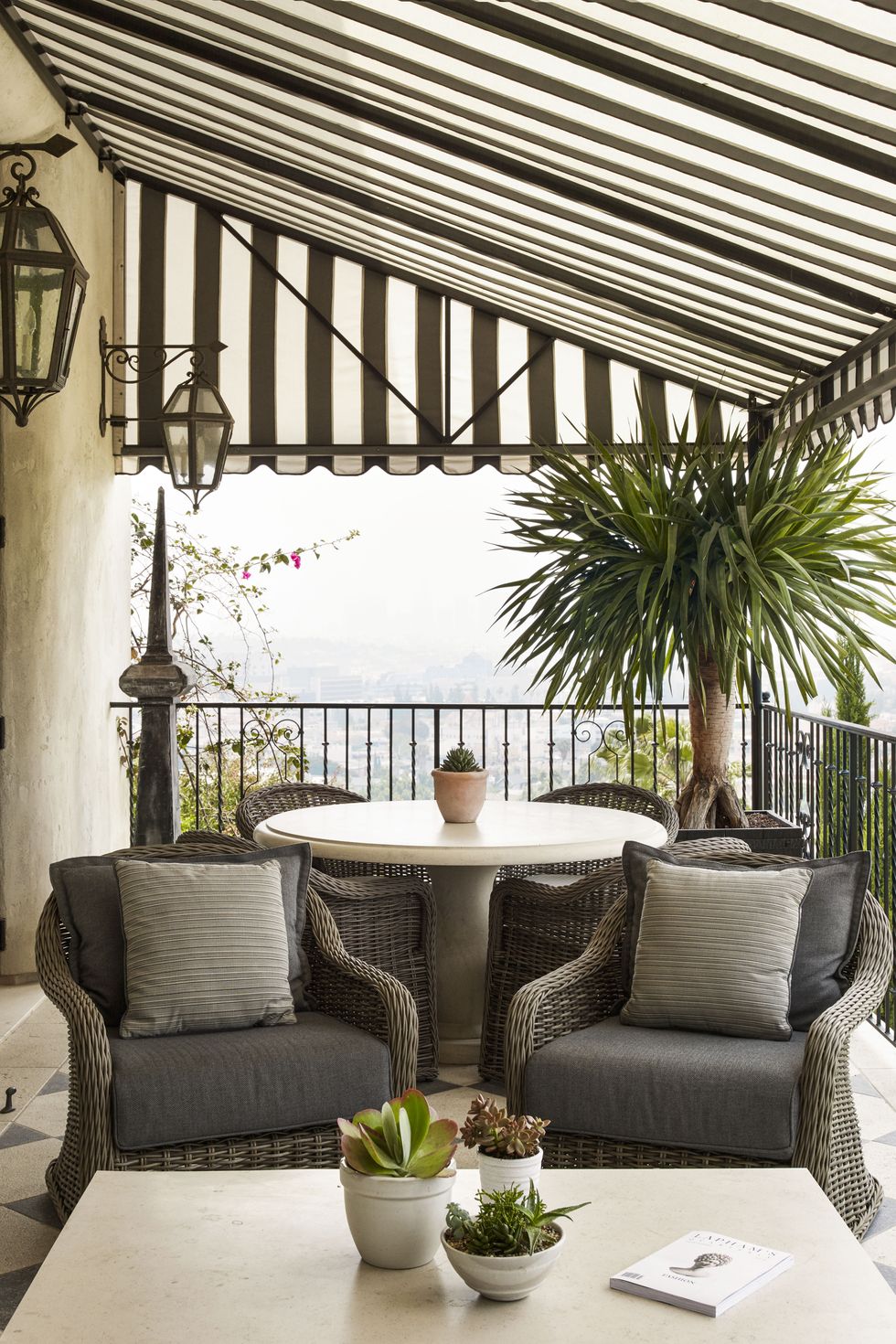 <p>Think of your porch or deck as a bonus room and dress it up with a traditional seating area and all the comforts of home. "Houses are expensive, so use every nook and cranny" to extend your space, says Ellen.</p><p><em>For similar: <strong>Awning,</strong> <a href="http://www.sunsetter.com/" target="_blank">sunsetter.com</a>. <strong>Havana lounge chairs,</strong> <a href="https://www.gloster.com/gla/" target="_blank">gloster.com</a>. <strong>Sunbrella Solid Indoor/Outdoor pillows,</strong> from $40 each, <a href="http://www.potterybarn.com/" target="_blank">potterybarn.com</a>. </em><em><strong>French Kitchen Round Bistro table,</strong> $899, <a href="http://www.crateandbarrel.com/" target="_blank">crateandbarrel.com</a>.</em></p>