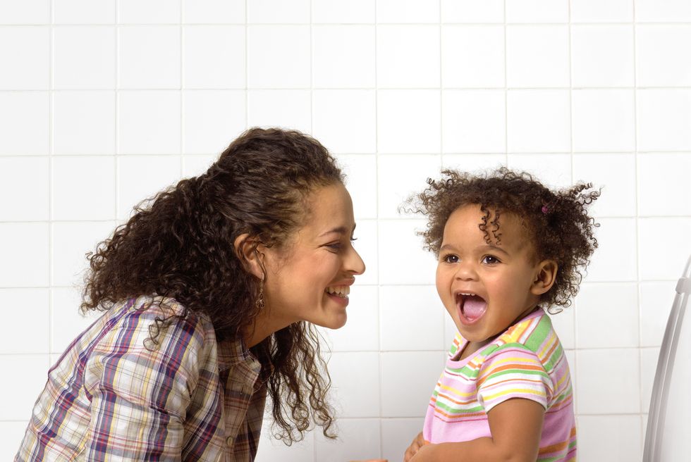 Potty Training. Little cute child girl sitting on a toilet. Stock Photo