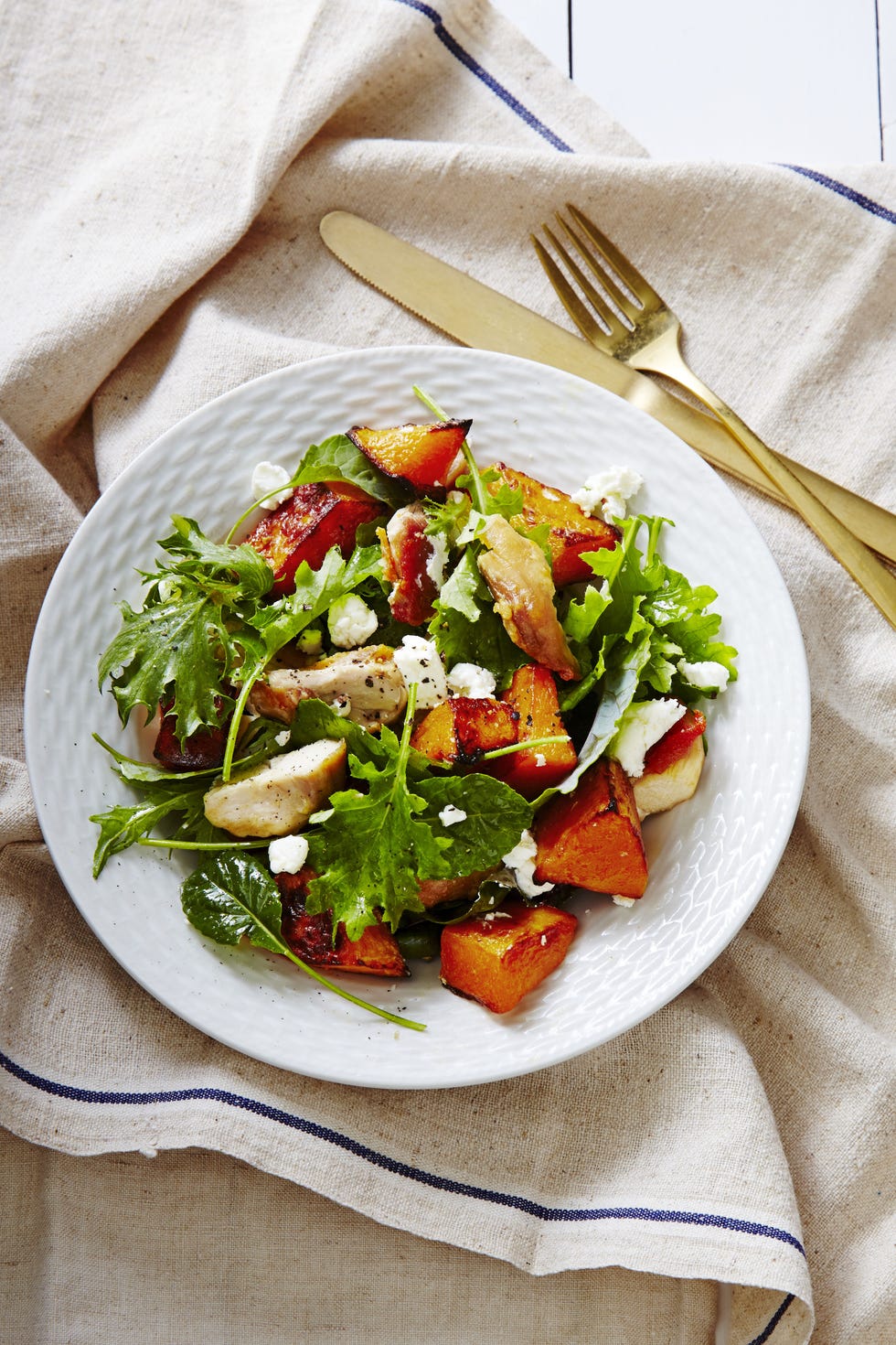 green salad with chicken, butternut squahs and goat cheese