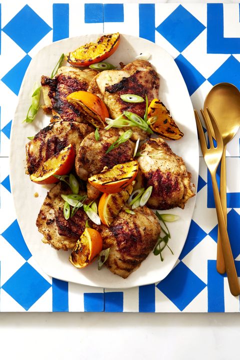 chipotle orange chicken with grilled peaches on a white plate