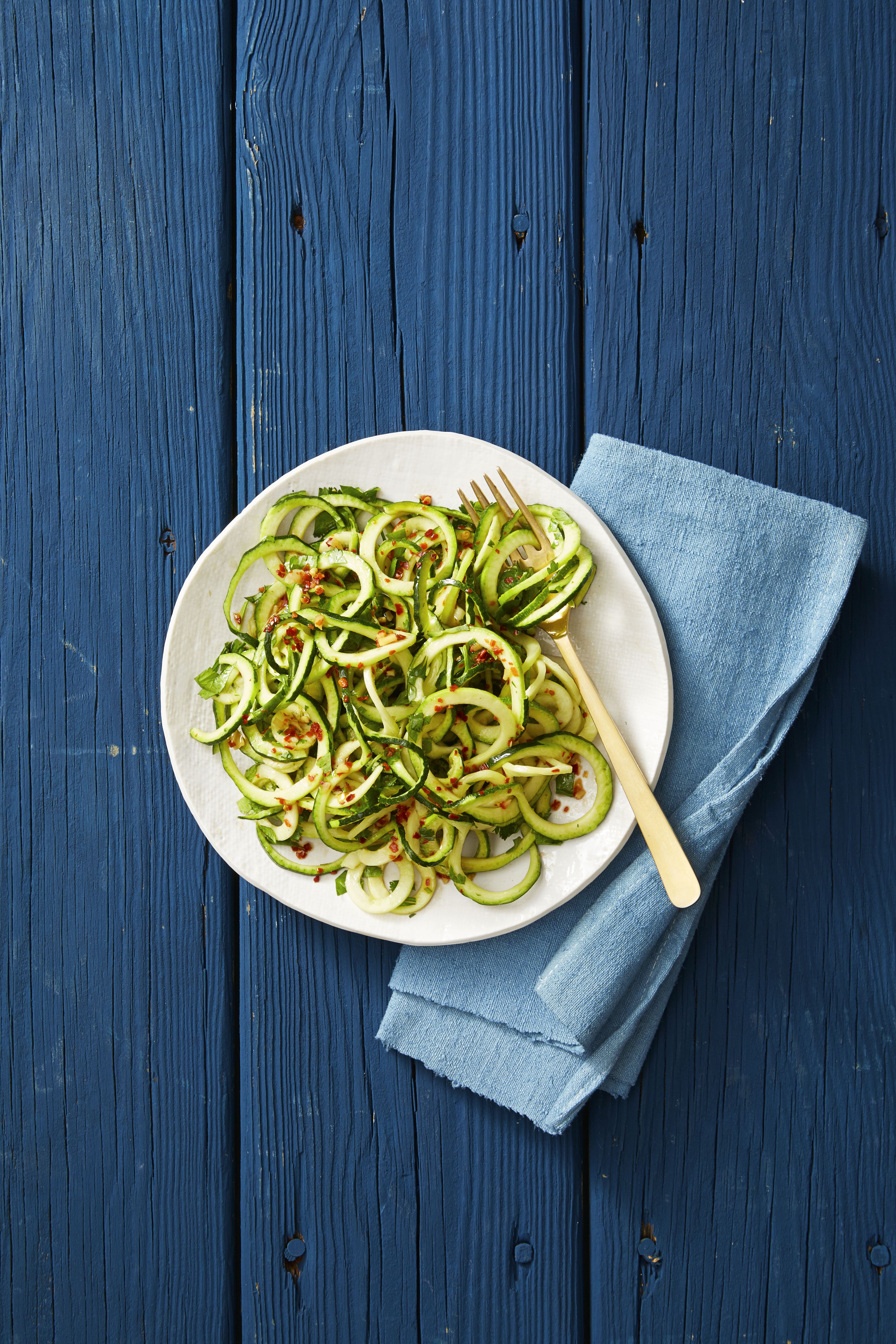 asian sesame zucchini noodles on a white plate