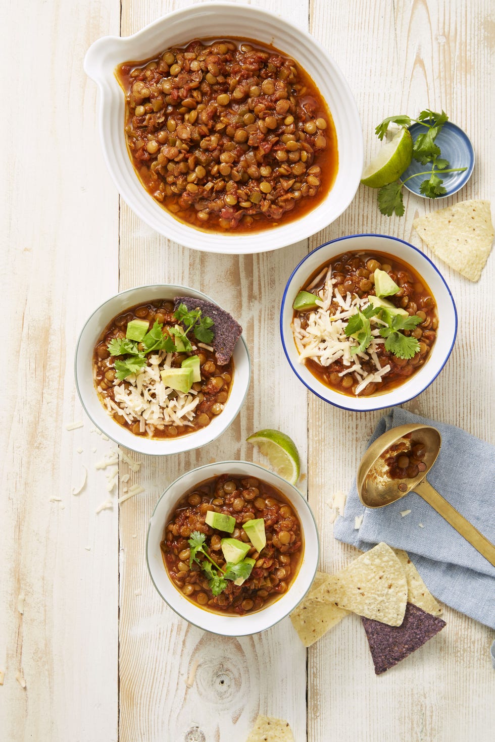 lentil chili with white shredded cheese on top in a white bowl