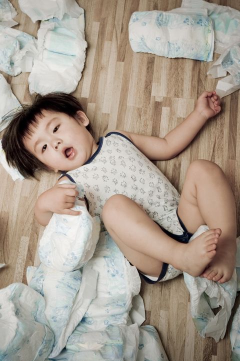 baby with diapers on floor