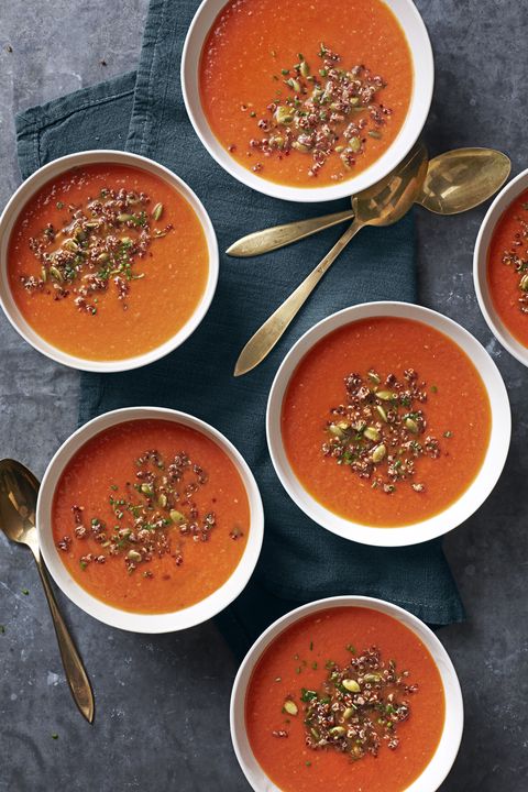several bowls of tomato quinoa soup with pumpkin seeds