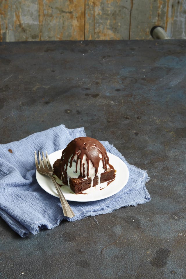 chocolate brownie with ice cream and a chocolate shell on top