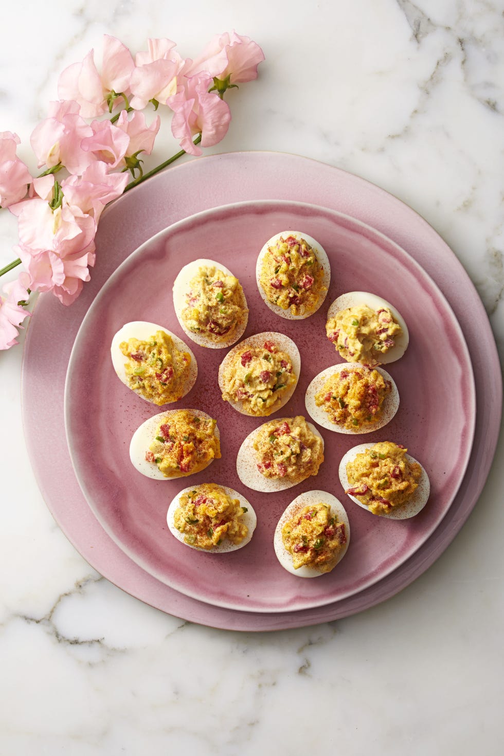 pimiento cheese deviled eggs on a pink plate