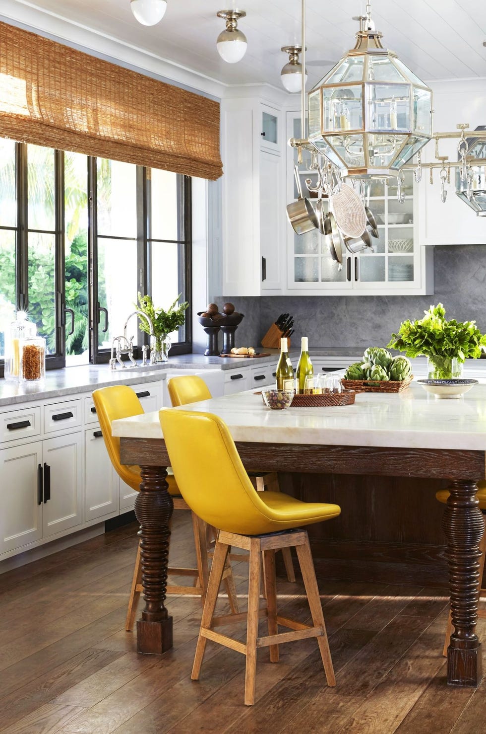 wood kitchen island with yellow dining chairs