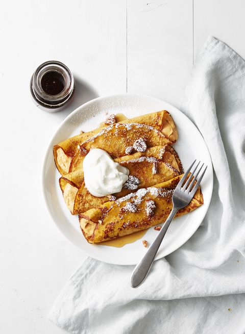 three pumpkin cheesecake crepes with whipped cream on top