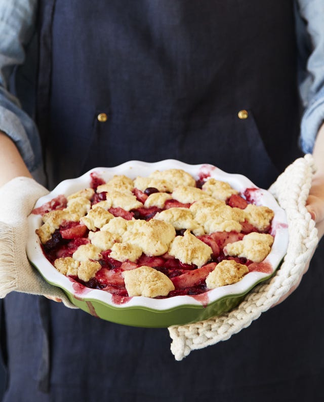 brown butter pear and cranberry cobbler in a green baking dish