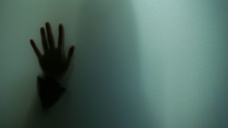Woman With Hand to Glass