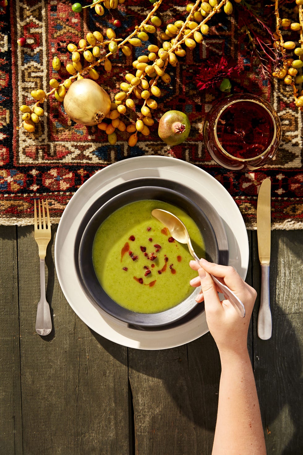 green potato and kale soup with crispy chorizo soup in a bowl