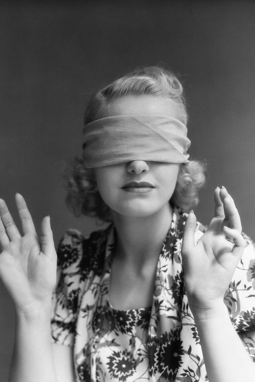 black and white photo of woman in blindfold