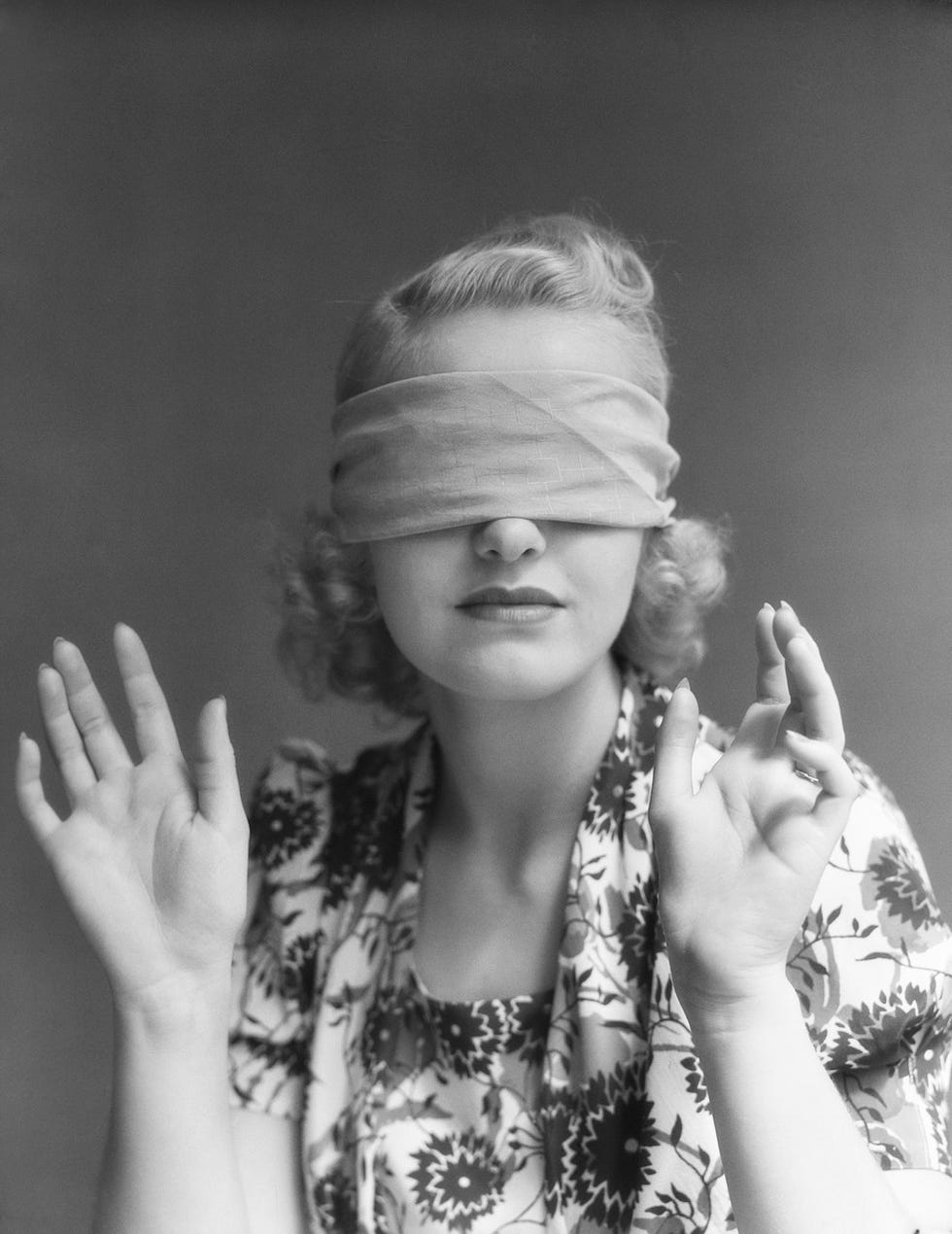 black and white photo of woman in blindfold