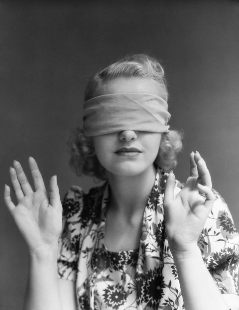 black and white photo of woman in blindfold