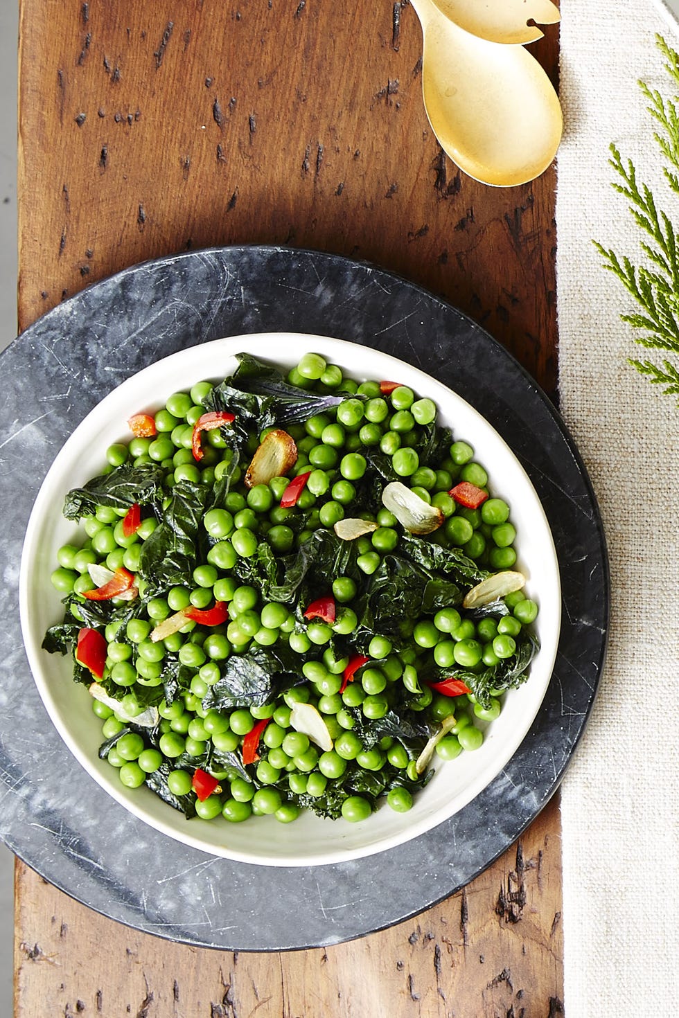 sautéd kale and peas on a white plate