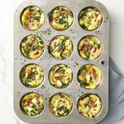 spinach and prosciutto frittata muffins in a muffin sheet pan