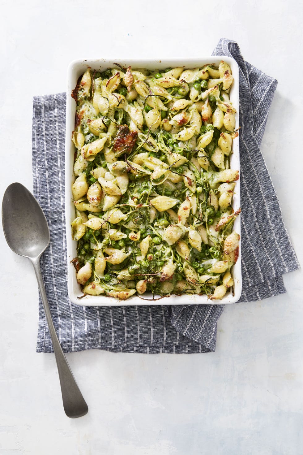 baked pesto shells in a casserole dish